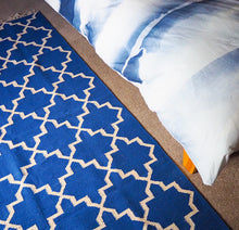 Load image into Gallery viewer, blue and white rug with bed
